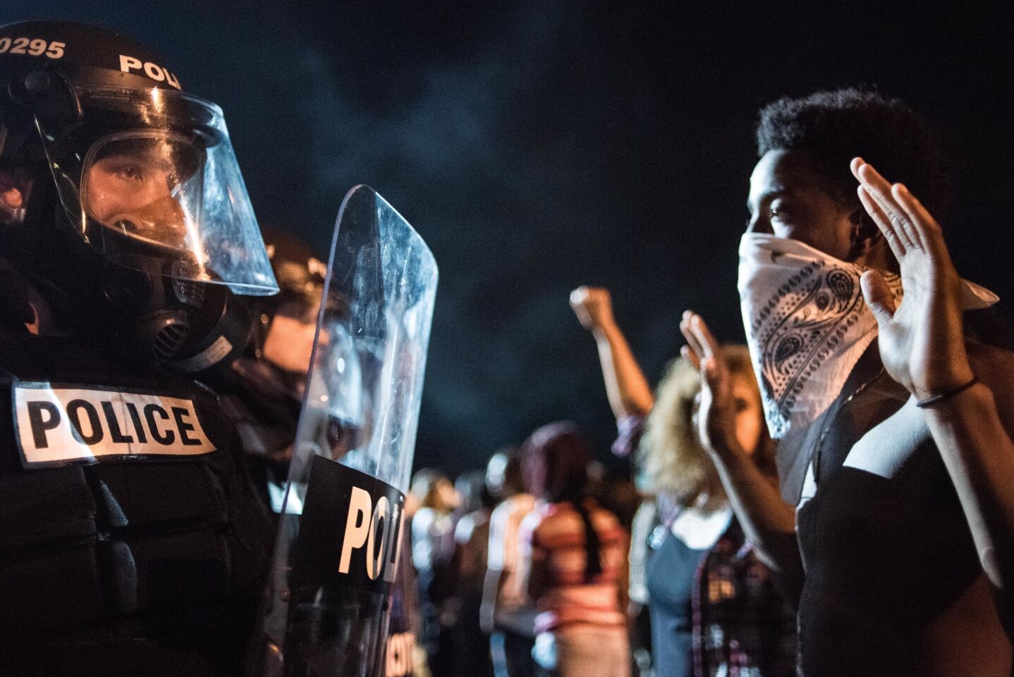 Police face off with protestors on Interstate 85 in Charlotte, N.C., during demonstrations after a man was shot to death by police.