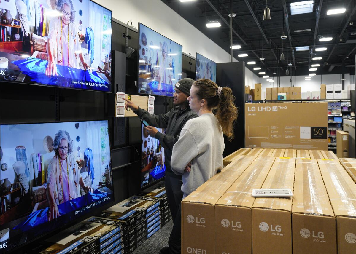 At Best Buy in Mission Valley, Jeff Hernandez and Sage Friel added to their list a new 60-inch flat-screen television.