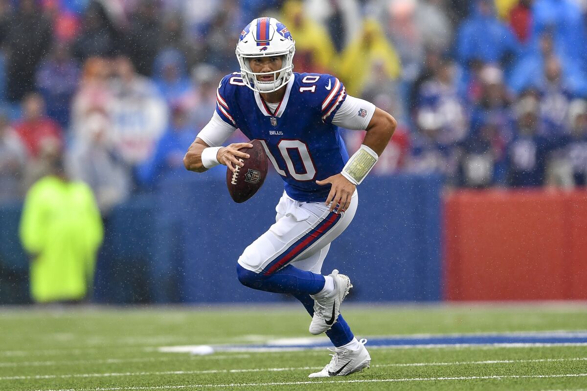 FILE - Buffalo Bills quarterback Mitchell Trubisky runs with the ball during the second half of an NFL football game against the Houston Texans, Sunday, Oct. 3, 2021, in Orchard Park, N.Y. A person with knowledge of the deal tells The Associated Press the Pittsburgh Steelers have agreed to terms on a two-year contract that will give Trubisky a chance to compete for the starting quarterback job following Roethlisberger's retirement in January. The person spoke to the AP on the condition of anonymity because the deal was not yet official. Financial details were not disclosed. (AP Photo/Adrian Kraus, File)