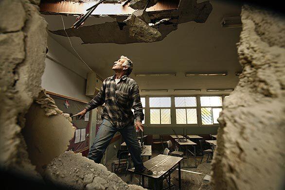 A rocket from the Gaza Strip tore through this school in the Israeli city of Beersheba, nearly 30 miles away. No one was hurt; classes had been canceled. Israel resisted calls to halt airstrikes on the Hamas-ruled Palestinian territory, saying it would keep pressure on the militant group while weighing proposals for a durable truce.