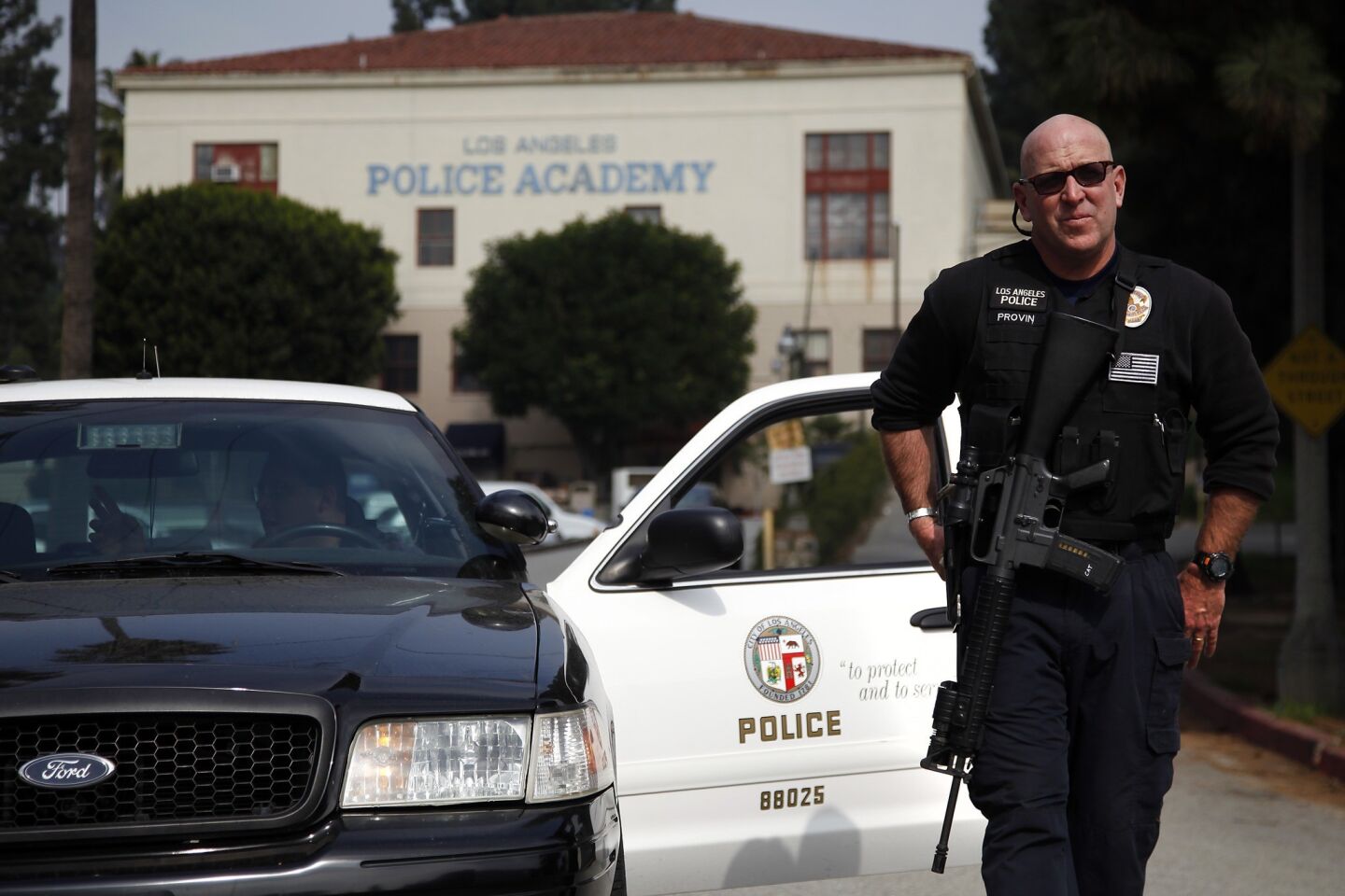 LAPD Officer Keith Provin keeps watch over the Los Angeles Police Academy, which was on heightened alert as the manhunt continued.