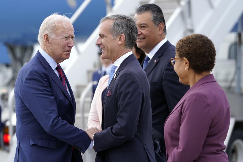 President Joe Biden greets, from front right, Rep. Karen Bass, D-Calif., Los Angeles Mayor Eric Garcetti, Sen. Alex Padilla, D-Calif., and his wife Angela Padilla, after arriving on Air Force One at Los Angeles International Airport, Wednesday, Oct. 12, 2022. (AP Photo/Carolyn Kaster)