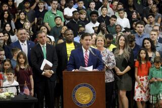 FILE - Arizona Gov. Doug Ducey speaks at an event touting a new universal school voucher program he signed into law in July and resigned again in a ceremony on Tuesday, Aug. 16, 2022 at Phoenix Christian Preparatory School in Phoenix, Ariz. All Arizona parents now can use state tax money to send their children to private or religious schools or pay homeschooling costs after an effort by public school advocates to block a massive expansion of the state's private school voucher law failed to collect enough signatures to block the law. (AP Photo/Bob Christie, File)