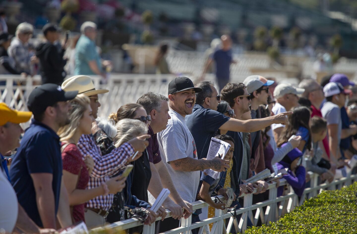 Fans cheer on their horses while watching the sixth race as Santa Anita opening day resumes racing at Santa Anita Horse Park in Arcadia, Calif., on March 29, 2019.
