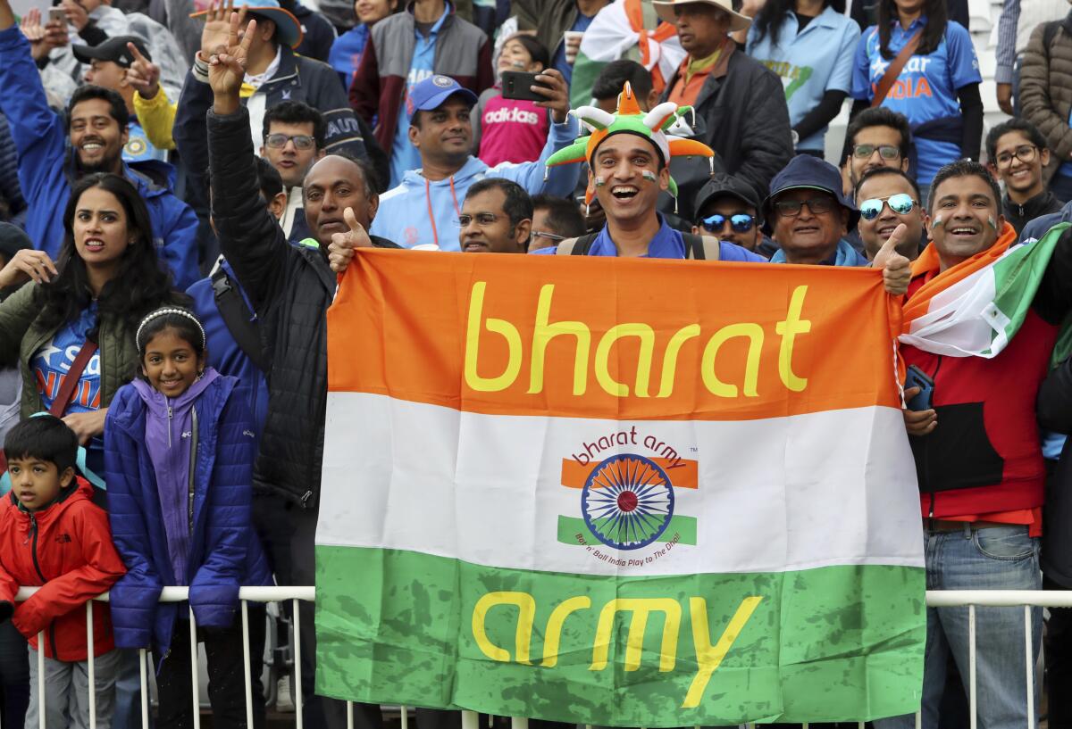 Indian cricket fan holding banner with the words 'Bharat Army'