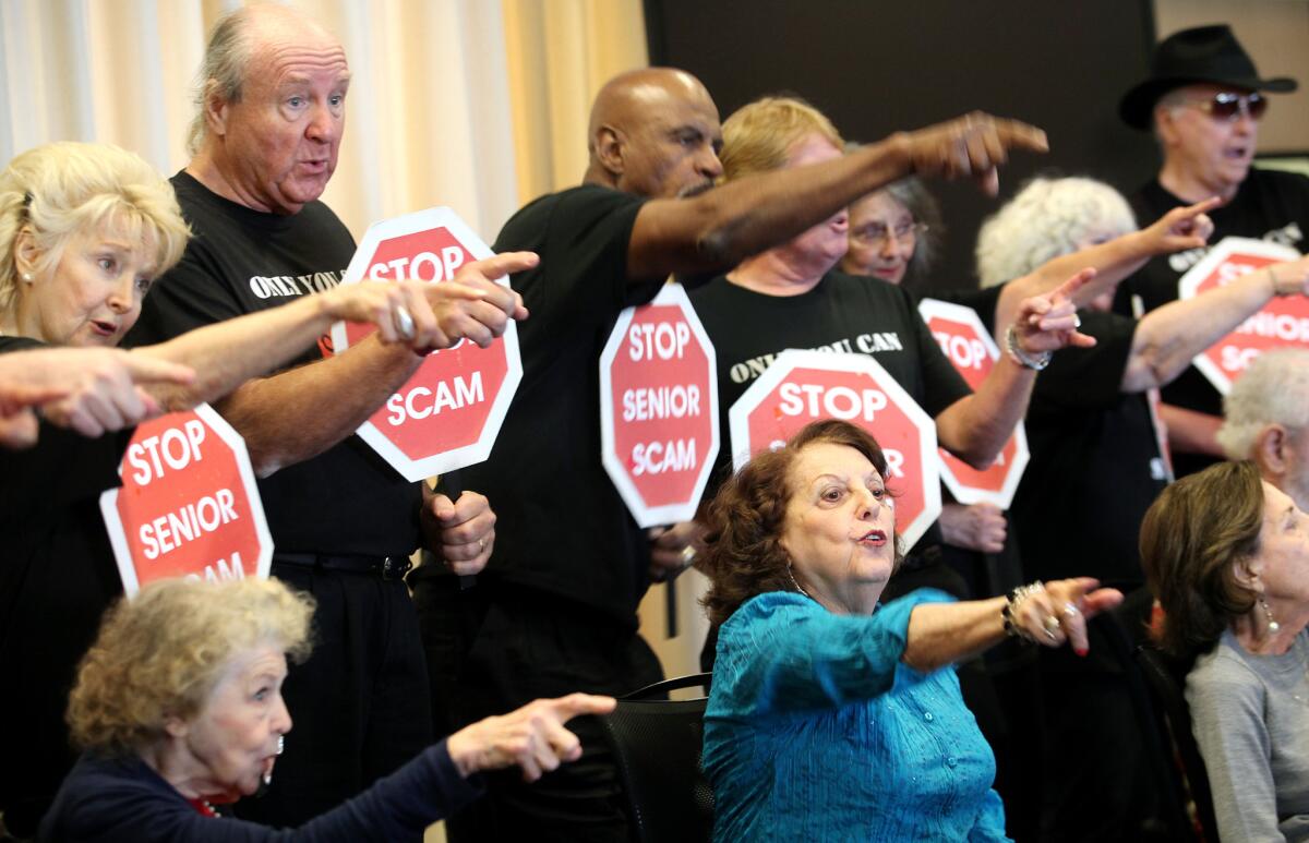 Participants with the Stop Senior Scams Acting Program perform a skit at Temple Judea in Tarzana during a program along with the Los Angeles Police Department.