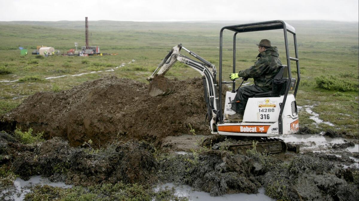 A worker with the Pebble Mine project test drills in Alaska's Bristol Bay region on July 13, 2007.