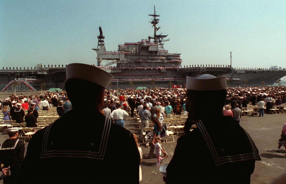 Sailors watch the decommissioning ceremonies for the U.S.S. Midway at North Island Naval Station. 