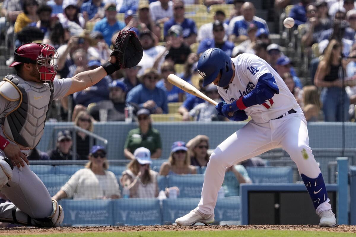 Miguel Vargas of the Dodgers ducks out of the of pitch that eludes Willson Contreras of the Cardinals in the fifth inning.