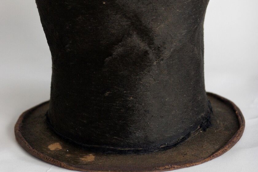 FILE - In this June 14, 2007 file photo, Abraham Lincoln's iconic stovepipe hat of questioned authenticity is photographed at the Abraham Lincoln Presidential Library and Museum in Springfield, Ill. A 16-month state study was unable to corroborate claims that a beaver-skin stovetop hat, a centerpiece of Illinois' Lincoln museum, once belonged to the 16th U.S. president, a Chicago-based public radio station reported Tuesday Dec. 24, 2019. Among the findings in the 54-page study was that the hat, once appraised at $6.5 million that, didn't appear to be Lincoln's size and that descendants of the original collectors weren't aware of the claim that Lincoln had owned the hat, WBEZ reported. (AP Photo/Seth Perlman File)