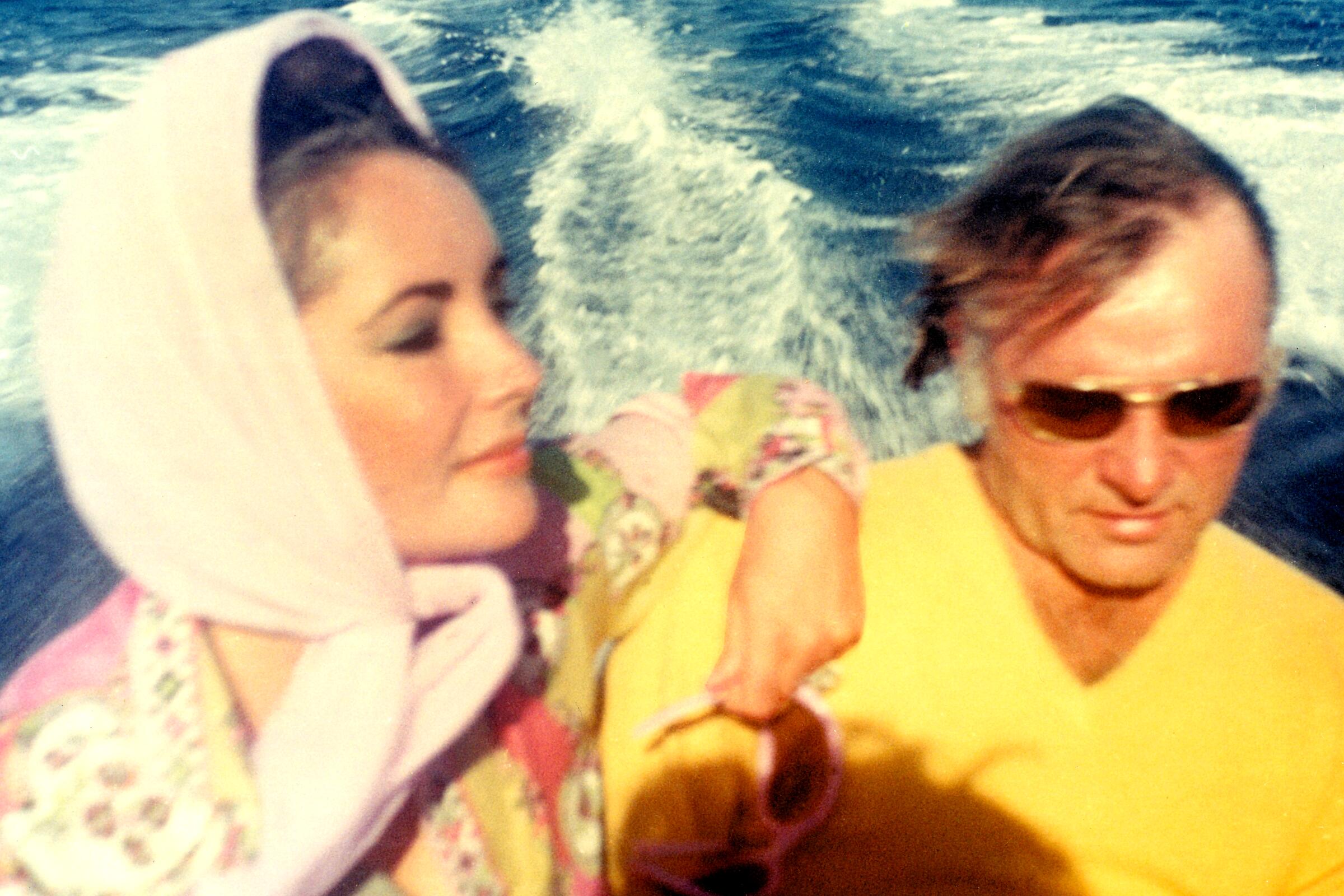 Elizabeth and Richard Burton in 1967 on board a speedboat along the coast of Sardinia, Italy.