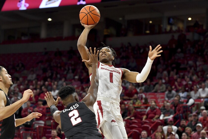 Arkansas guard JD Notae (1) shoots over Pennsylvania guard Jonah Charles (2) during the first half of an NCAA college basketball game Sunday, Nov. 28, 2021, in Fayetteville, Ark. (AP Photo/Michael Woods)
