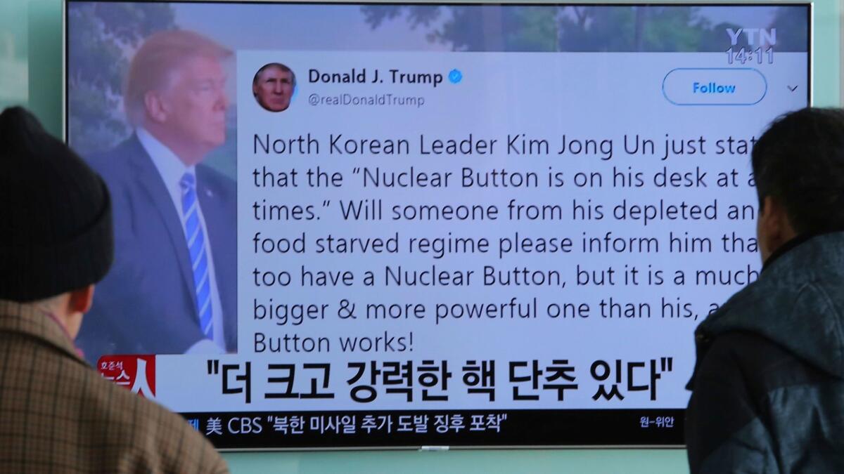 People in Seoul watch a TV news program on Jan. 3 showing a tweet by President Trump about his "nuclear button."
