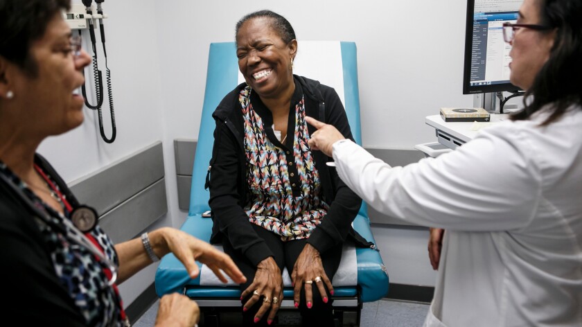 Dr. Susan Claster, left, and Dr. Bernadette Manalo, right, talk to patient Philadelphia Philpot at the Martin Luther King Jr. Outpatient Center's new sickle cell clinic.