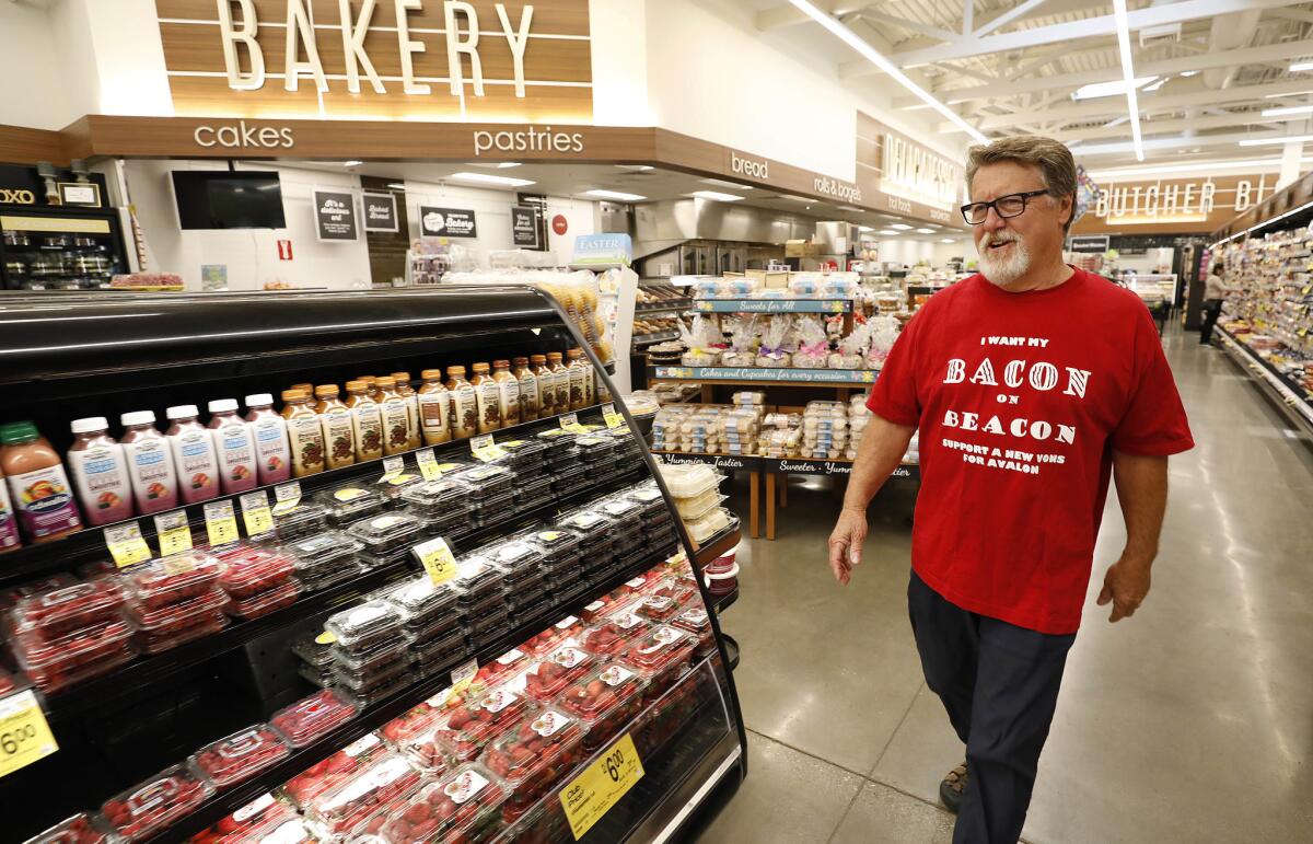 John King, who headed the campaign to bring a bigger Vons to the island wears one of his campaign T-shirts that reads "I Want my Bacon on Beacon" (Beacon is one of the streets where the Vons is located). (Al Seib / Los Angeles Times)