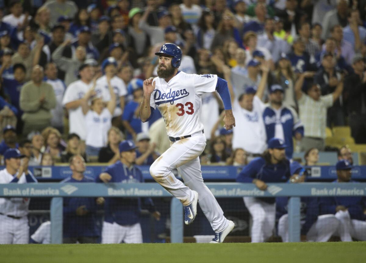 Dodgers outfielder Scott Van Slyke hustles home to score a run in the seventh inning against the Marlins.