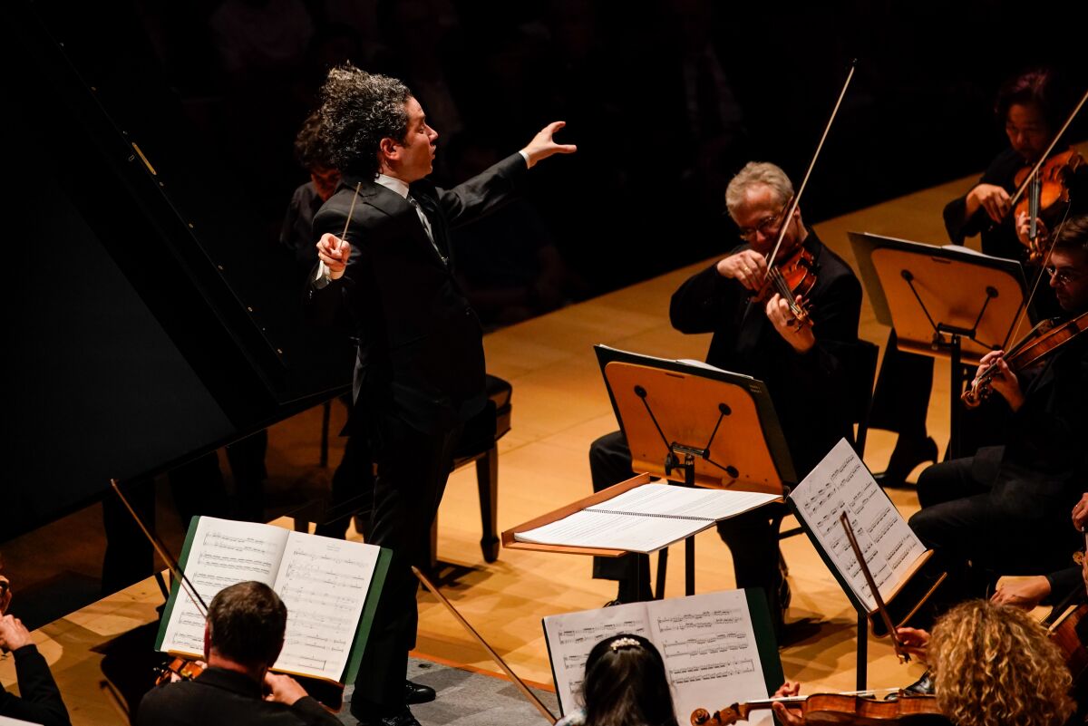 Gustavo Dudamel conducts the Los Angeles Philharmonic in the world premiere of Esteban Benzecry’s Piano Concert with pianist Sergio Tiempo at Walt Disney Concert Hall on Thursday. 