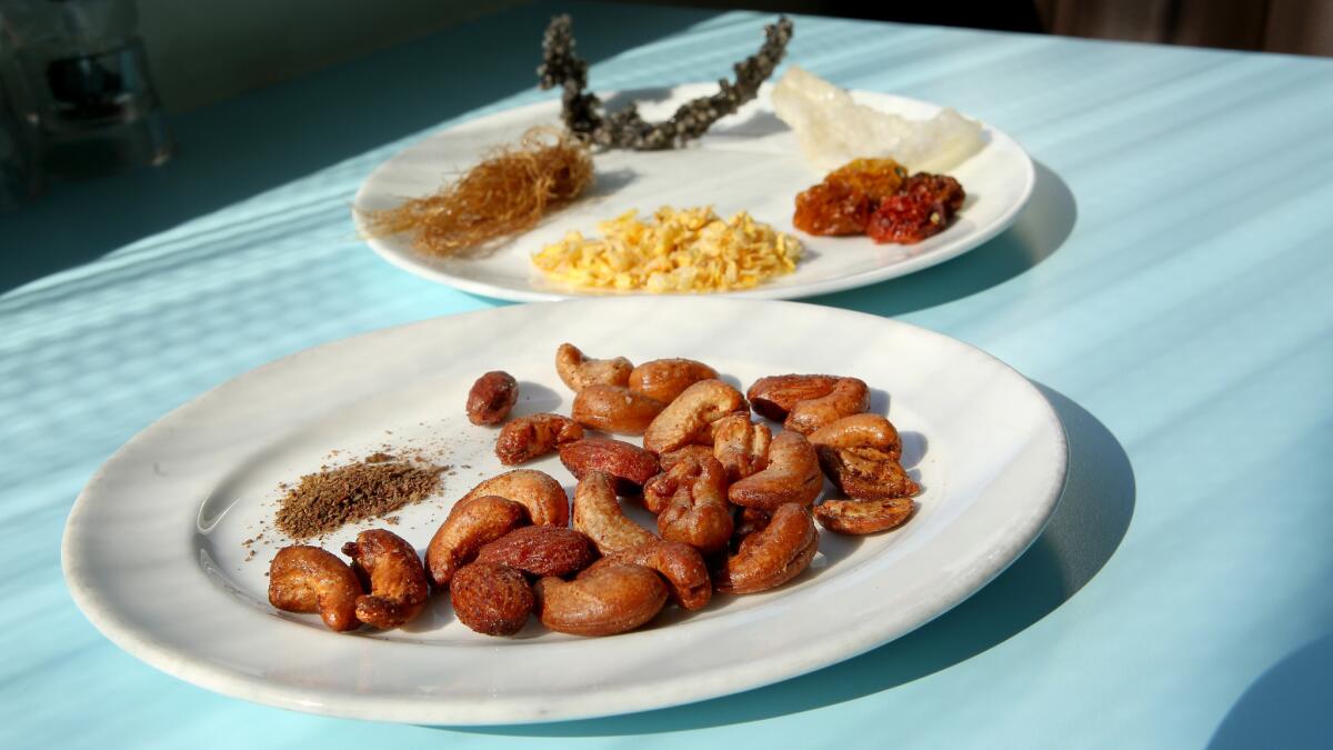 Kimchi Cashews and Almonds, Kimchi powder, corn silk, Tapioca squid ink, puffed onion chip, cherry tomatoes and dry corn kernels.