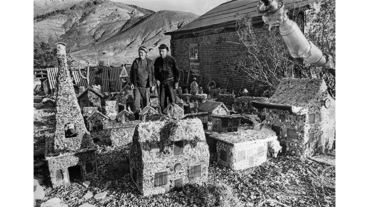 Feb. 1969: Mary and Tommy Thompson live in a bottle house, right, in Rhyolite, Nev. They stand in model of Rhyolite made by Tommy from glass.