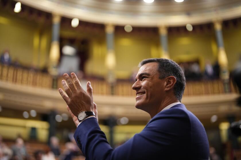 Spain's acting Prime Minister Pedro Sanchez applauds during the investiture debate and vote at the Spanish Parliament in Madrid, Spain, Thursday, Nov. 16, 2023. Sanchez has defended his controversial amnesty deal for Catalonia's separatists in parliament and seeks the endorsement of the chamber to form a new government. (AP Photo/Manu Fernandez)