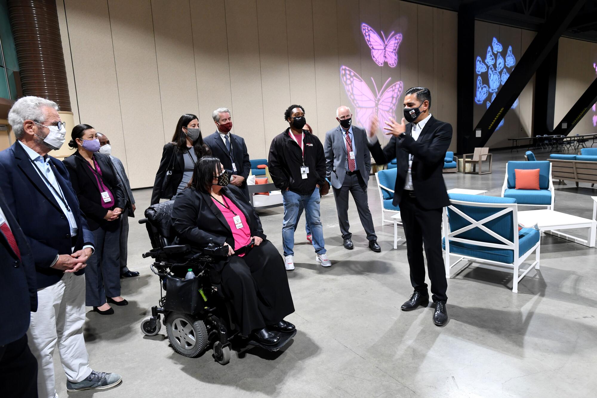 Mayor Robert Garcia shows officials a living area