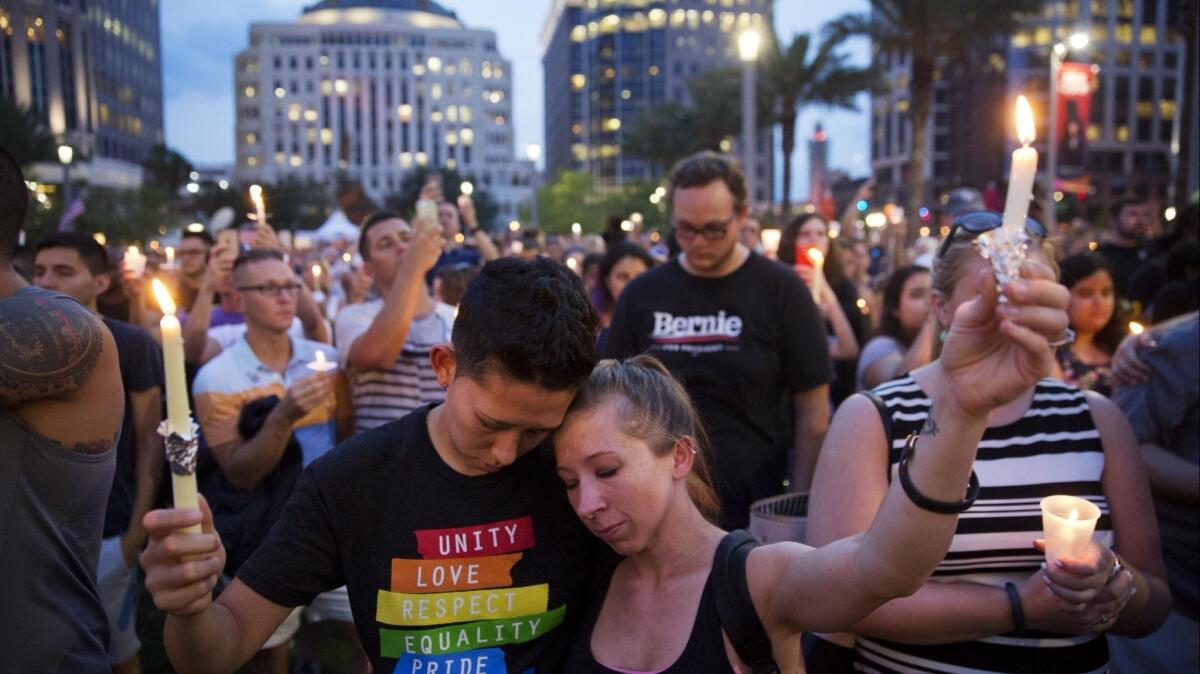 Mourners hold candles during a vigil in downtown Orlando, Fla., after the Pulse nightclub shooting in June 2016.