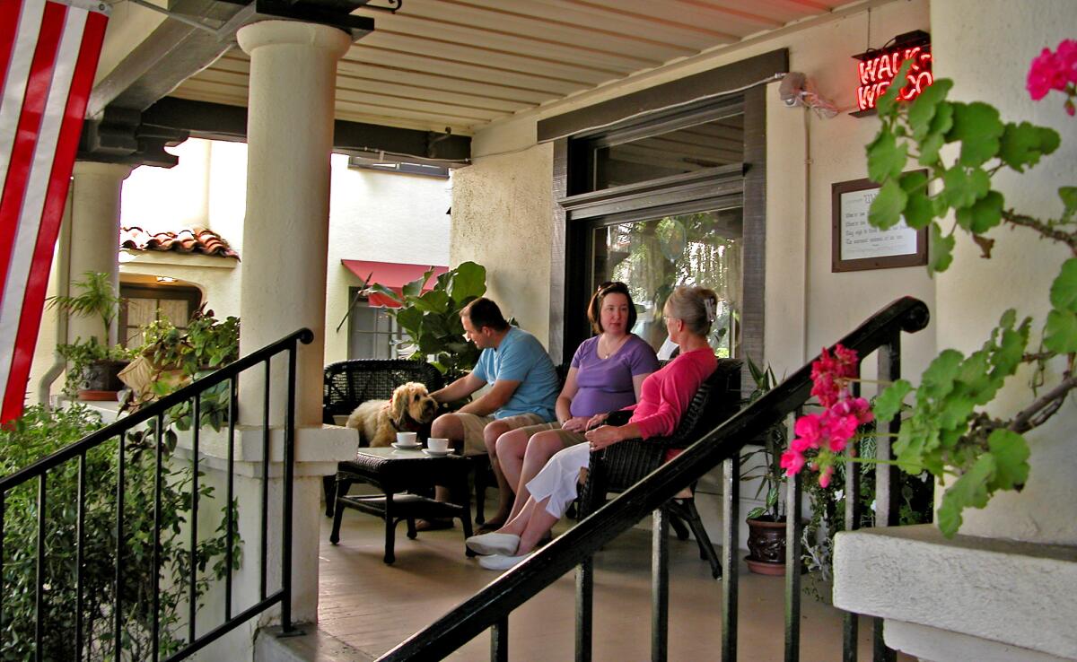 Visitors, including Darby, get to know each other on the front porch at the Old Yacht Club Inn B&B in Santa Barbara.