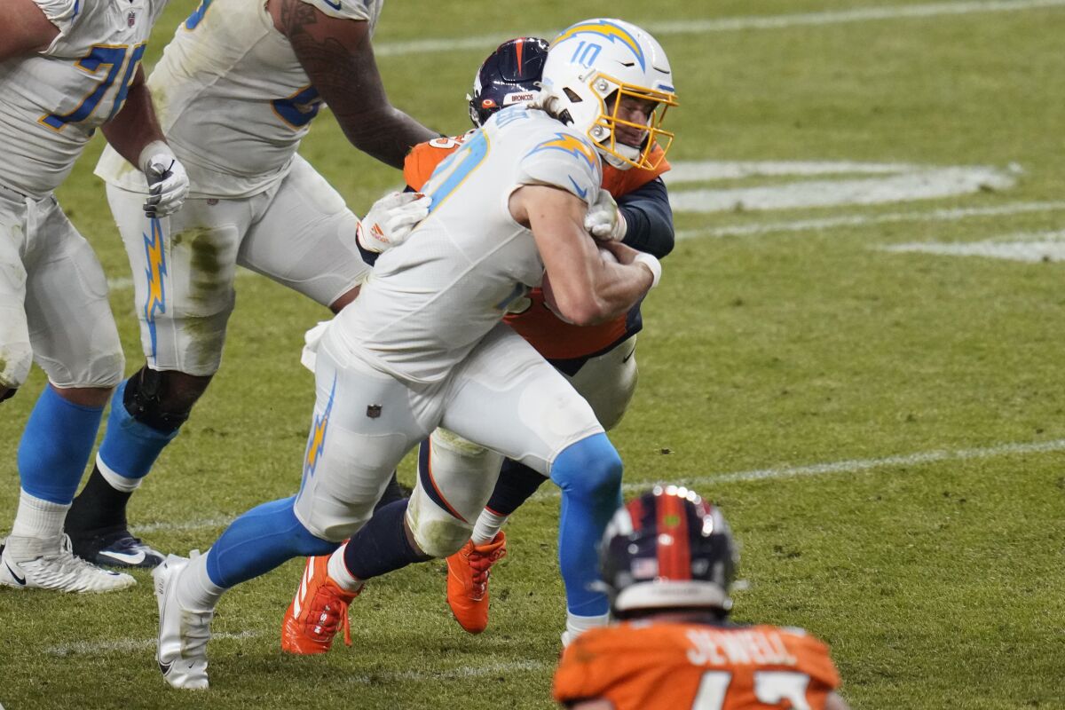 Chargers quarterback Justin Herbert scrambles against the Denver Broncos during the second half Sunday.