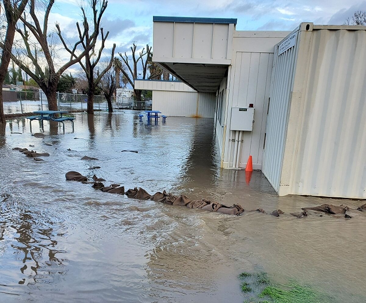 Flood water laps up to Planada Elementary School building exteriors.