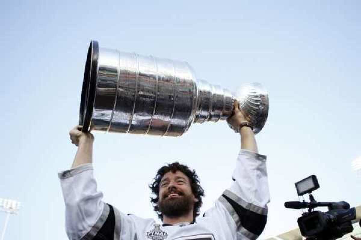 LA Kings player Justin Williams raises the Stanley Cup into the air before the baseball game between the Los Angeles Dodgers and Los Angeles Angels.