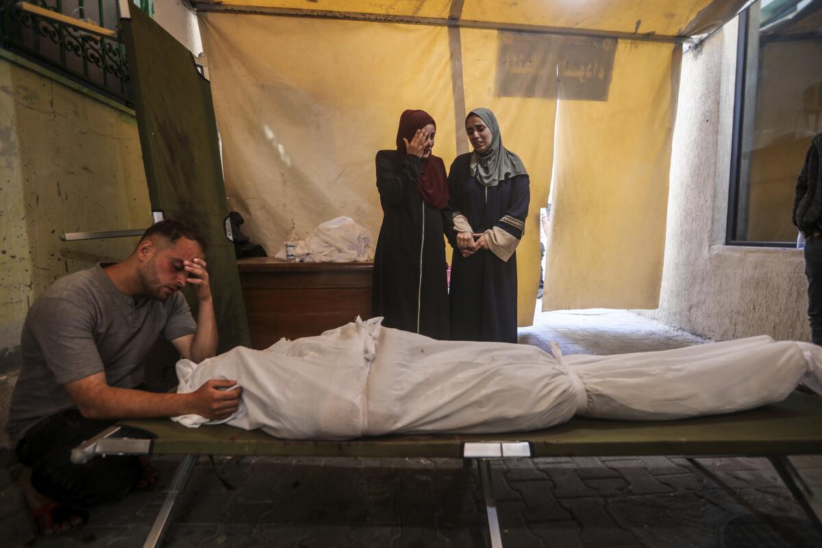 Palestinians mourn their relatives at a hospital in Rafah, Gaza.