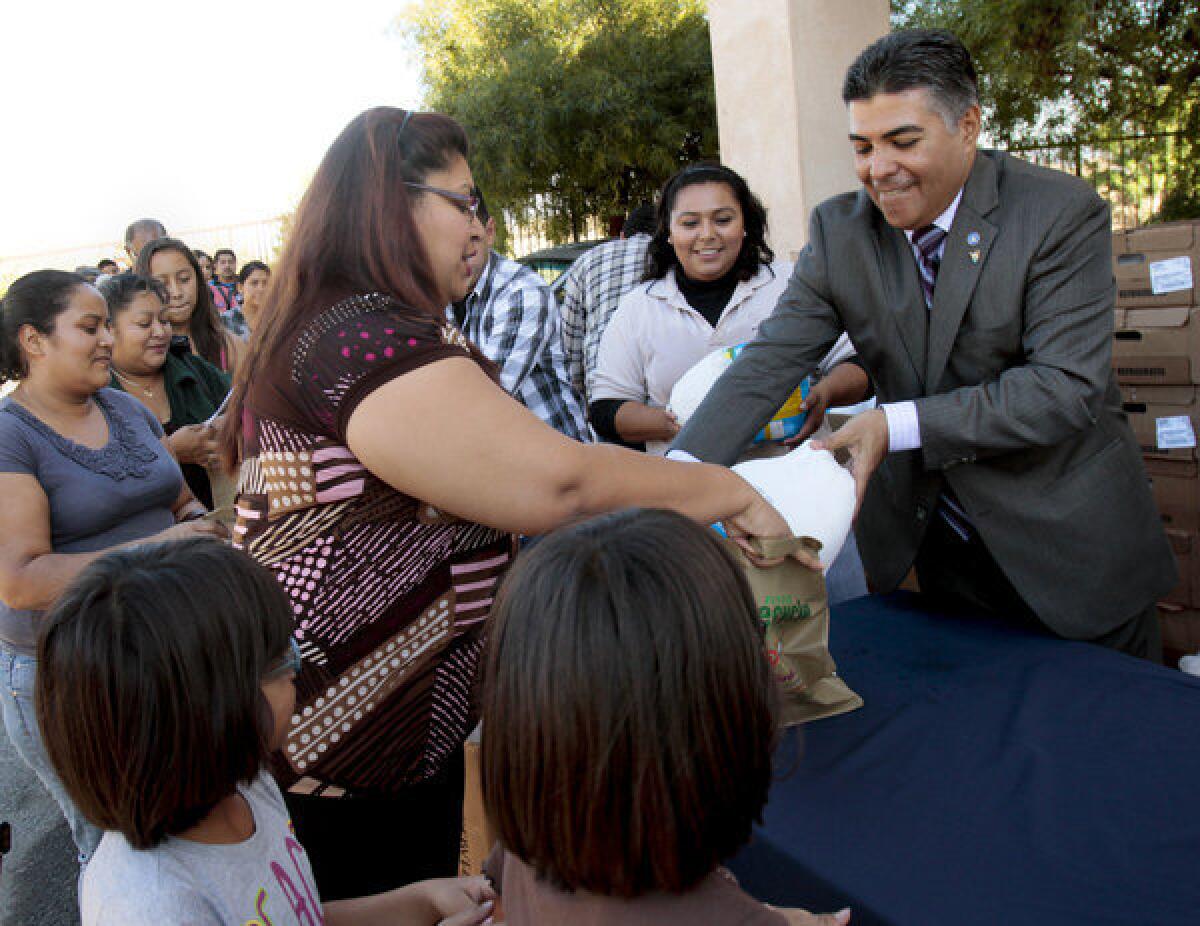 Rep. Tony Cardenas, then a Los Angeles councilman, gives turkeys to constituents in Sun Valley before Thanksgiving last year.