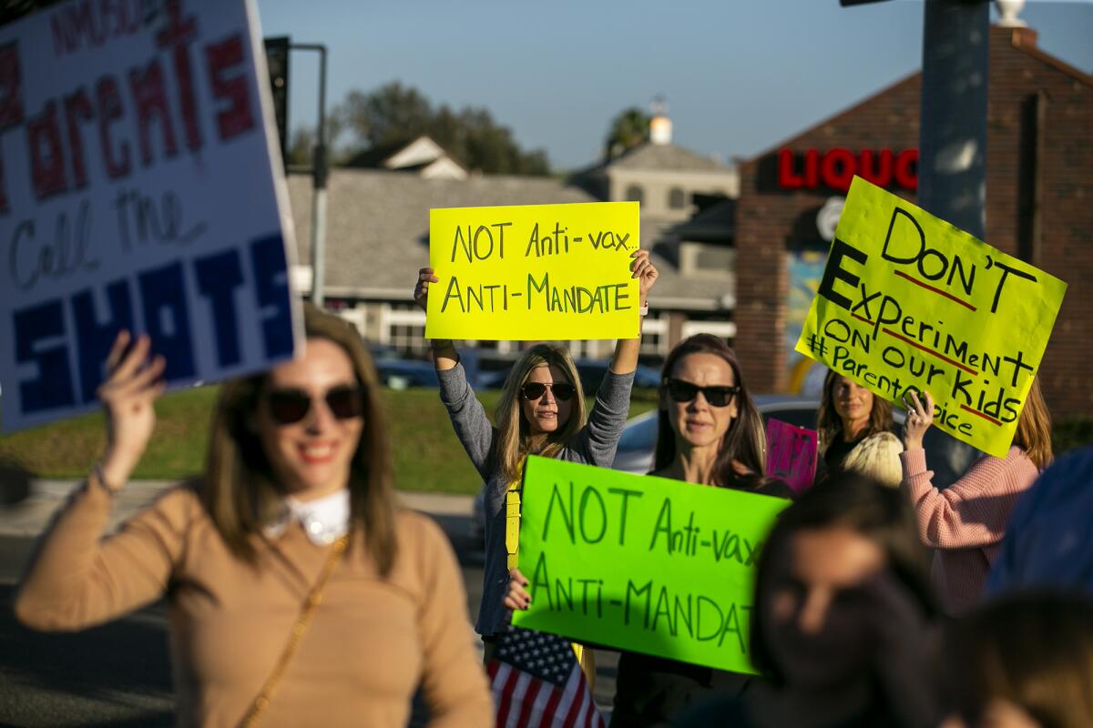 Parents and teachers participate in a rally.