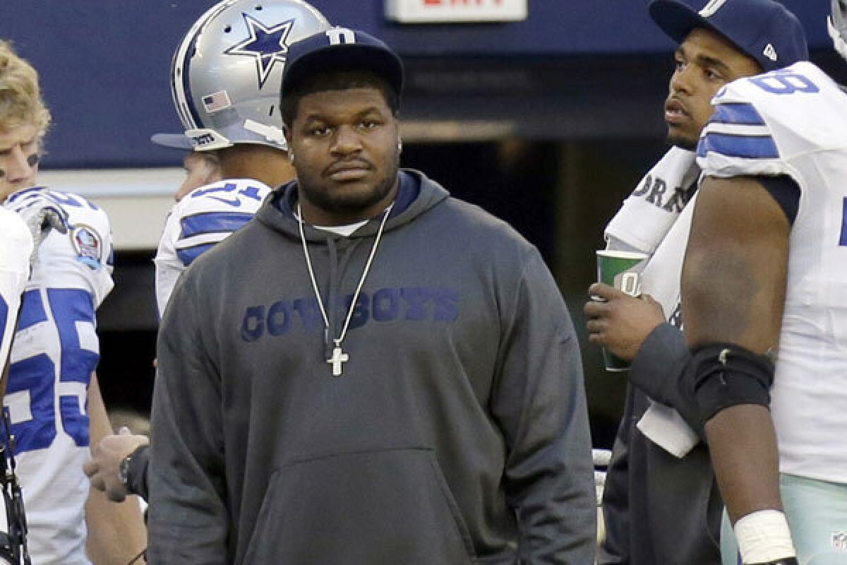 Nose tackle Josh Brent watches from the Dallas Cowboys sideline Sunday against the Pittsburgh Steelers.