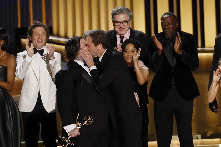 Matty Matheson and Ebon Moss-Bachrach kiss on stage at the Emmys
