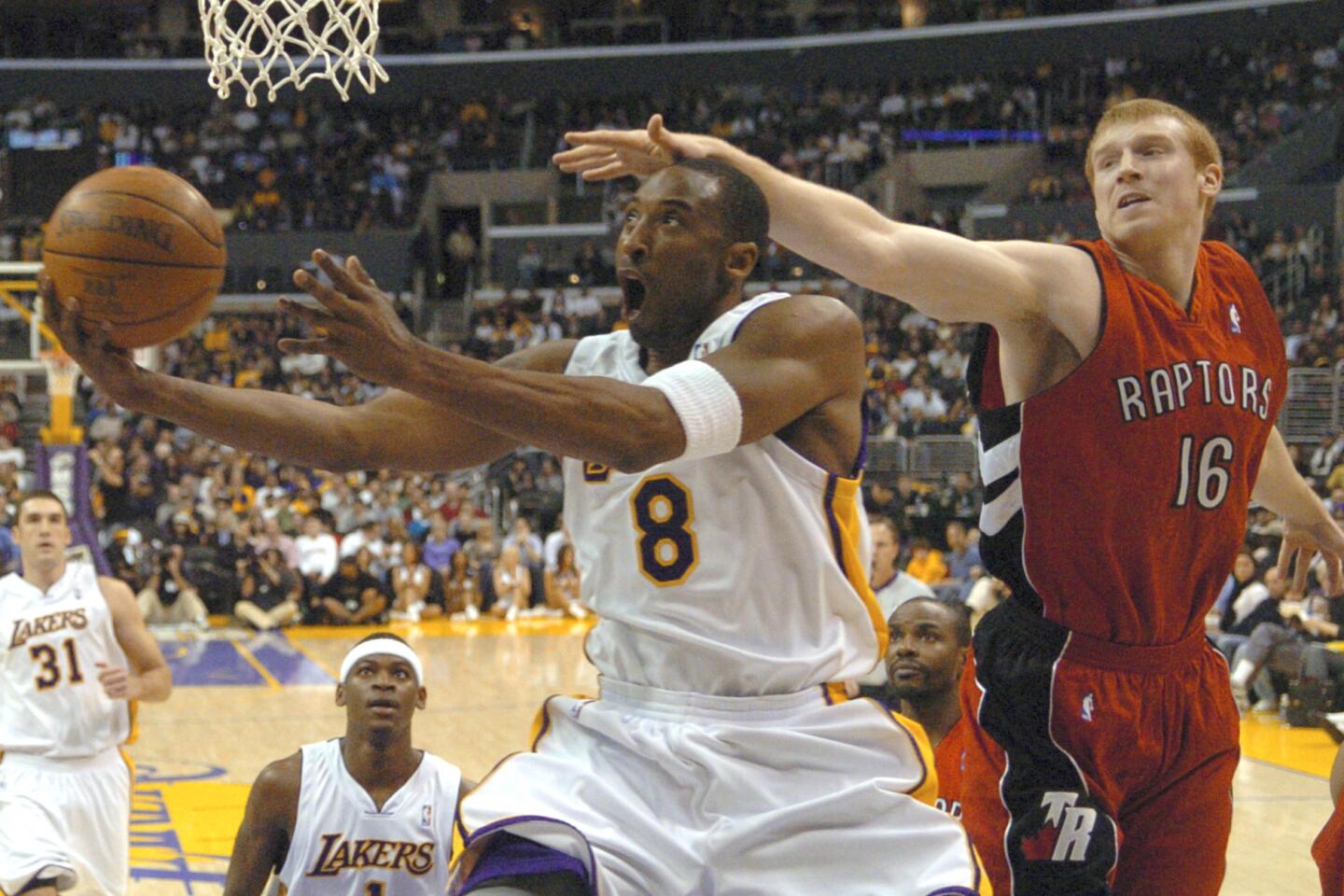 Toronto's Matt Bonner reaches for the ball just before Kobe Bryant scores two of his 81 points against the Raptors on Jan. 22, 2006.