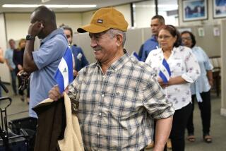 CORRECTS LAST NAME TO SOSA - Victor Manuel Sosa Herrera holds a Nicaraguan flag as he arrives with other recently released political prisoners from Nicaragua, for a news conference at the office of Miami-Dade County Mayor Daniella Levine-Cava, Wednesday, Feb. 15, 2023, in Miami. Nicaraguan President Daniel Ortega recently sent 222 political leaders, priests, students, activists and other dissidents to the United States, whose release was long demanded by the international community. (AP Photo/Lynne Sladky)