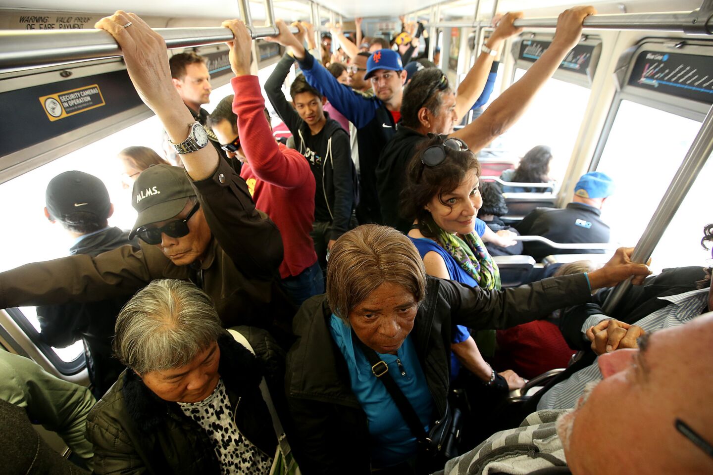 Riders experience cramped conditions during the first day of Expo Line trains running to Santa Monica, on Friday, May 20.