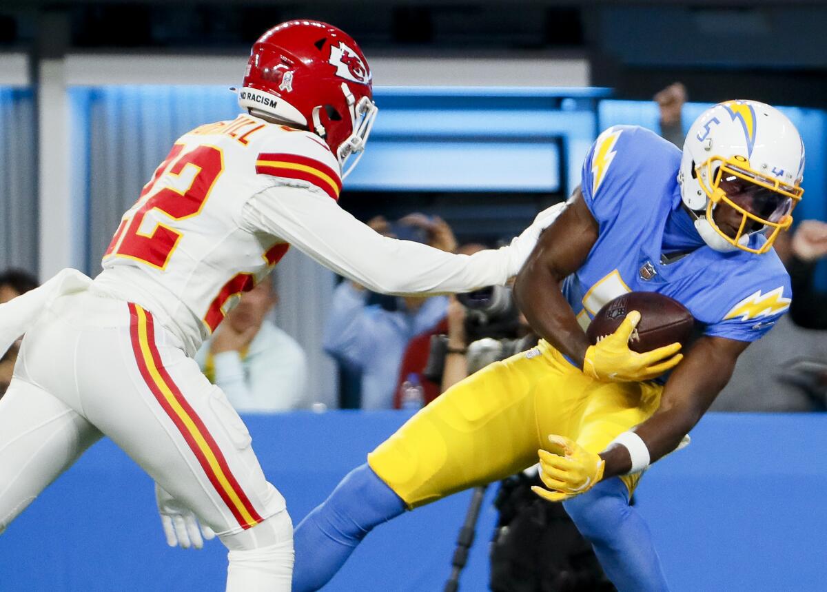 The Chargers' Joshua Palmer (5) catches a pass for a touchdown in front Chiefs safety Juan Thornhill.