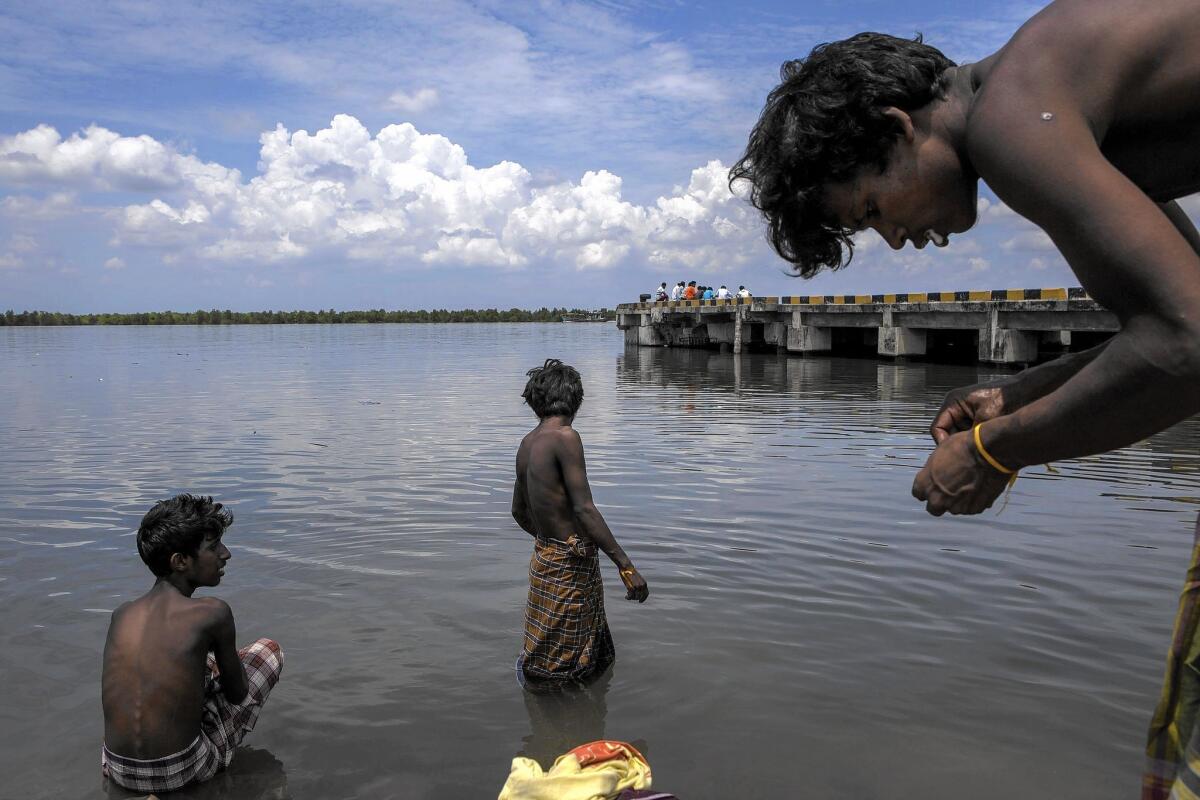 Bangladeshi migrants bathe in the sea at a temporary shelter in Kuala Langsa, Aceh province, Indonesia, on May 18, 2015.