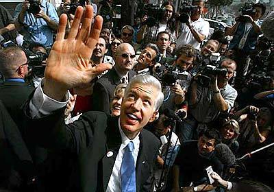 Governor Gray Davis is greeted by a throng of media in West Hollywood. Appearing upbeat, Davis said he felt "absolutely terrific," and encouraged all Californians, "however you vote," to cast a ballot in the election.