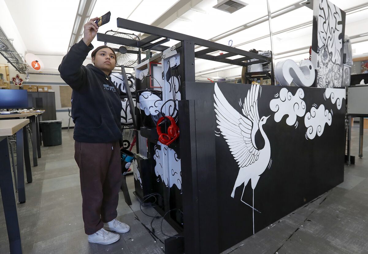 Melisa Javier, a senior in an art production class at Laguna Beach High, works on a floral pop-up art project.