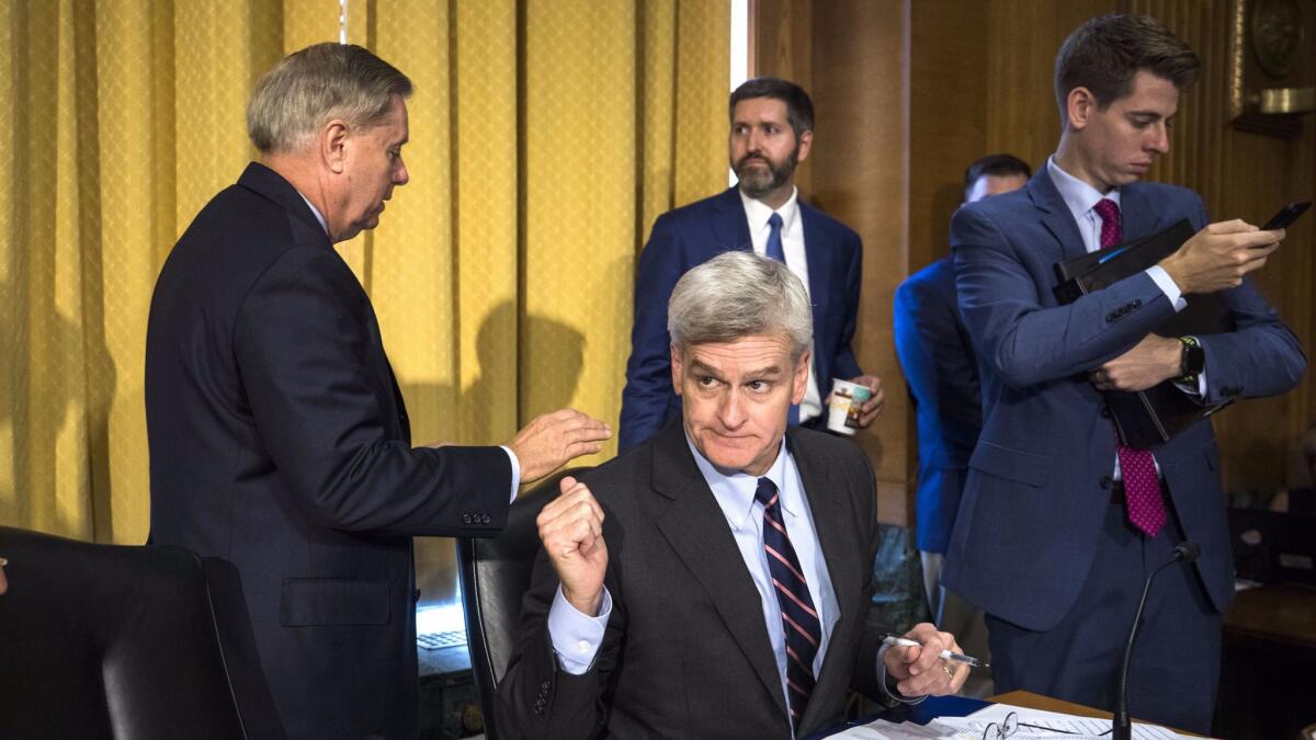 Senators Lindsey Graham (R-S.C), left, and Bill Cassidy (R-La) before a Senate Finance Committee hearing about the Graham-Cassidy Health Care Bill in Washington on Sept. 25.