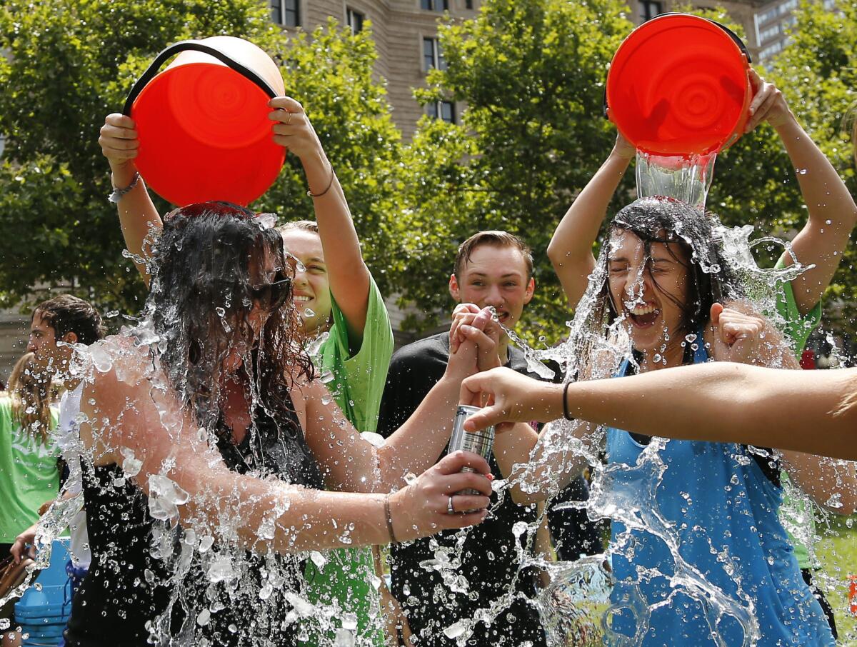 Two women get doused during the Ice Bucket Challenge at Boston's Copley Square to raise funds and awareness for ALS in August 2014.