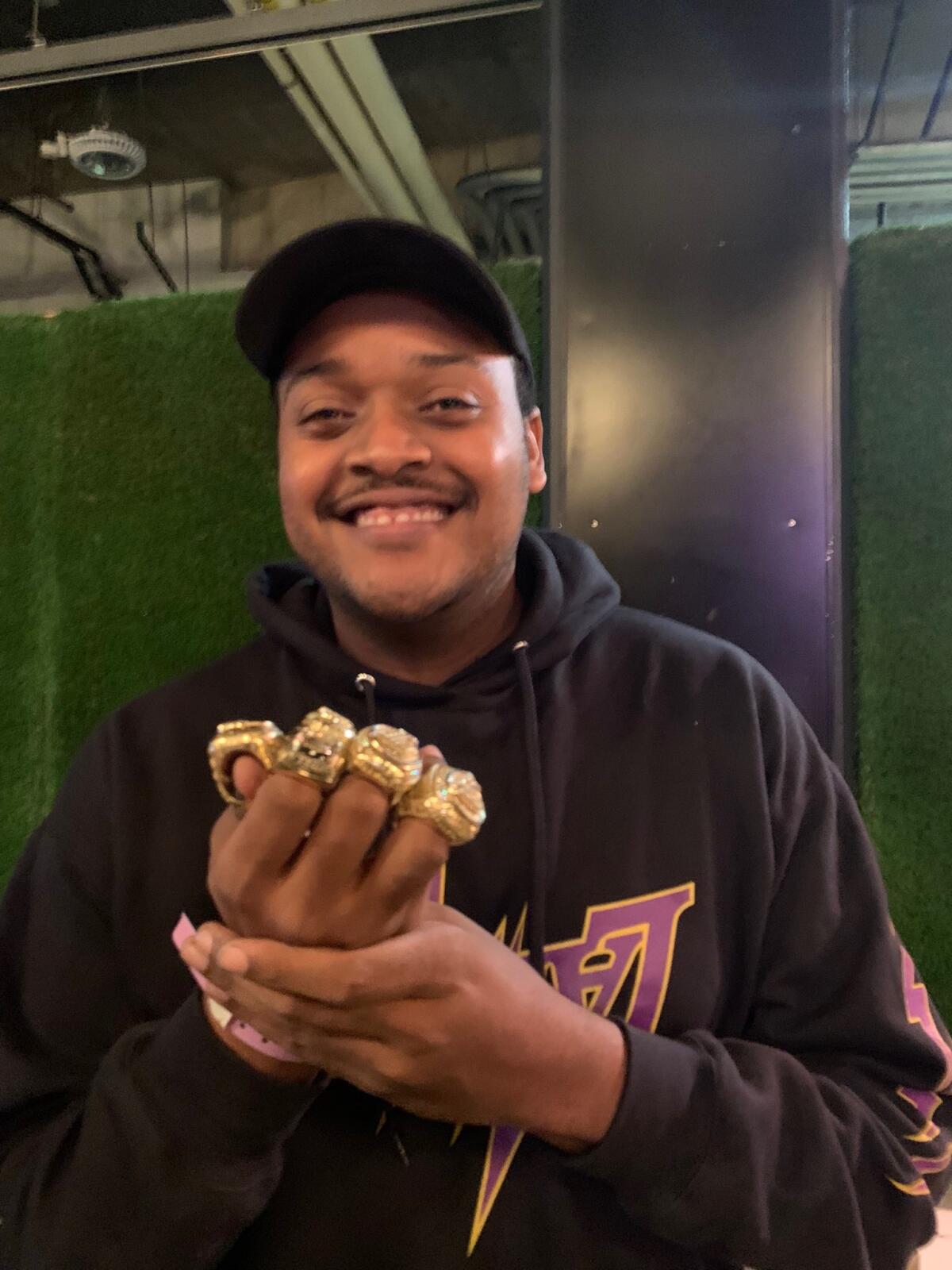 Darrian Woods shows off the Lakers championship rings 