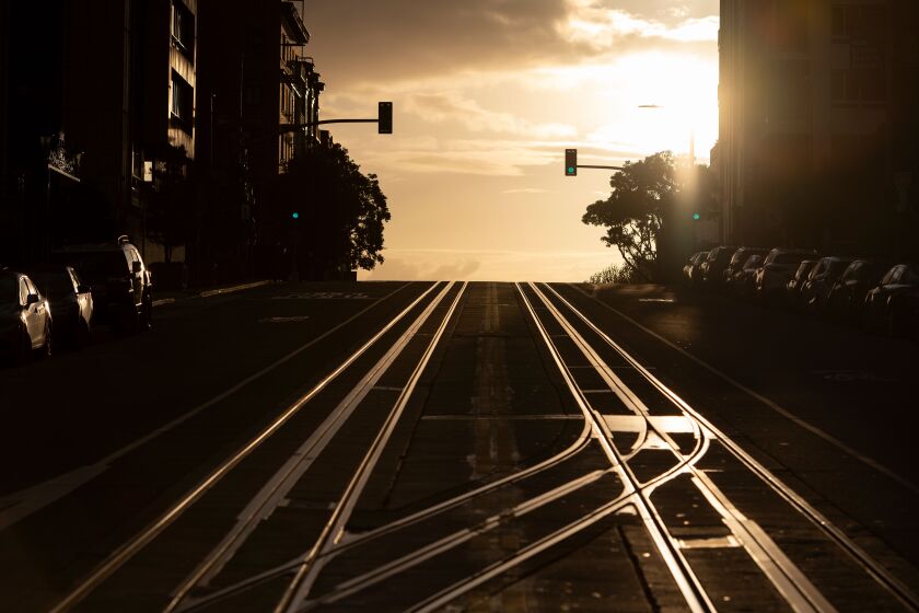 California Street, usually filled with cable cars, is seen empty in San Francisco, California on March 18, 2020. - San Francisco, along with seven other Bay Area counties, have ordered residents to shelter in place in an effort to help prevent the spread of the coronavirus. (Photo by Josh Edelson / AFP) (Photo by JOSH EDELSON/AFP via Getty Images)