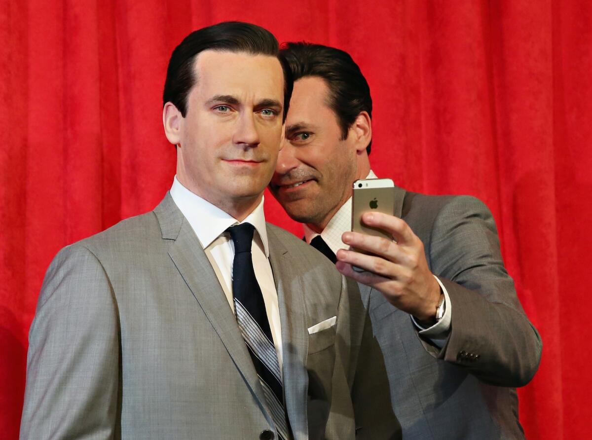 NEW YORK, NY - MAY 09: Actor Jon Hamm takes a selfie as he unveils Don Draper's wax figure during Mad Men's Final Season at Madame Tussauds New York on May 9, 2014 in New York City. (Photo by Cindy Ord/Getty Images for Madame Tussauds)