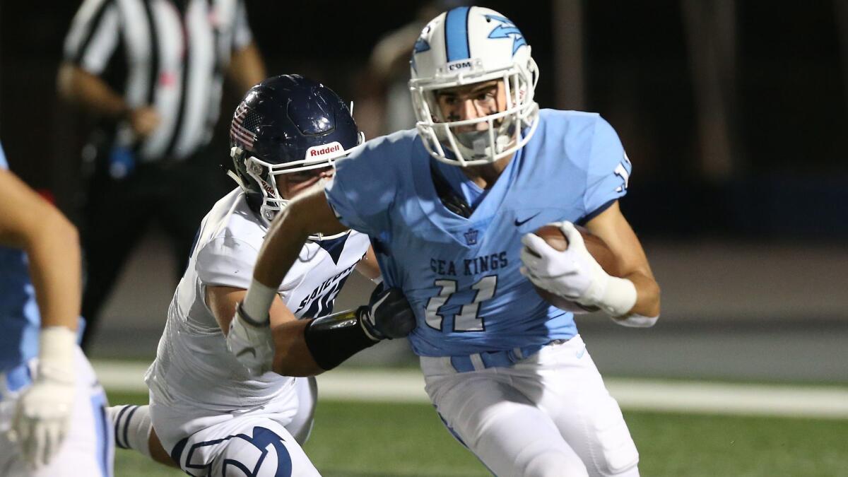 Corona del Mar's Bradley Schlom breaks away from a Newport Harbor defender in the Battle of the Bay at Davidson Field on Friday night.