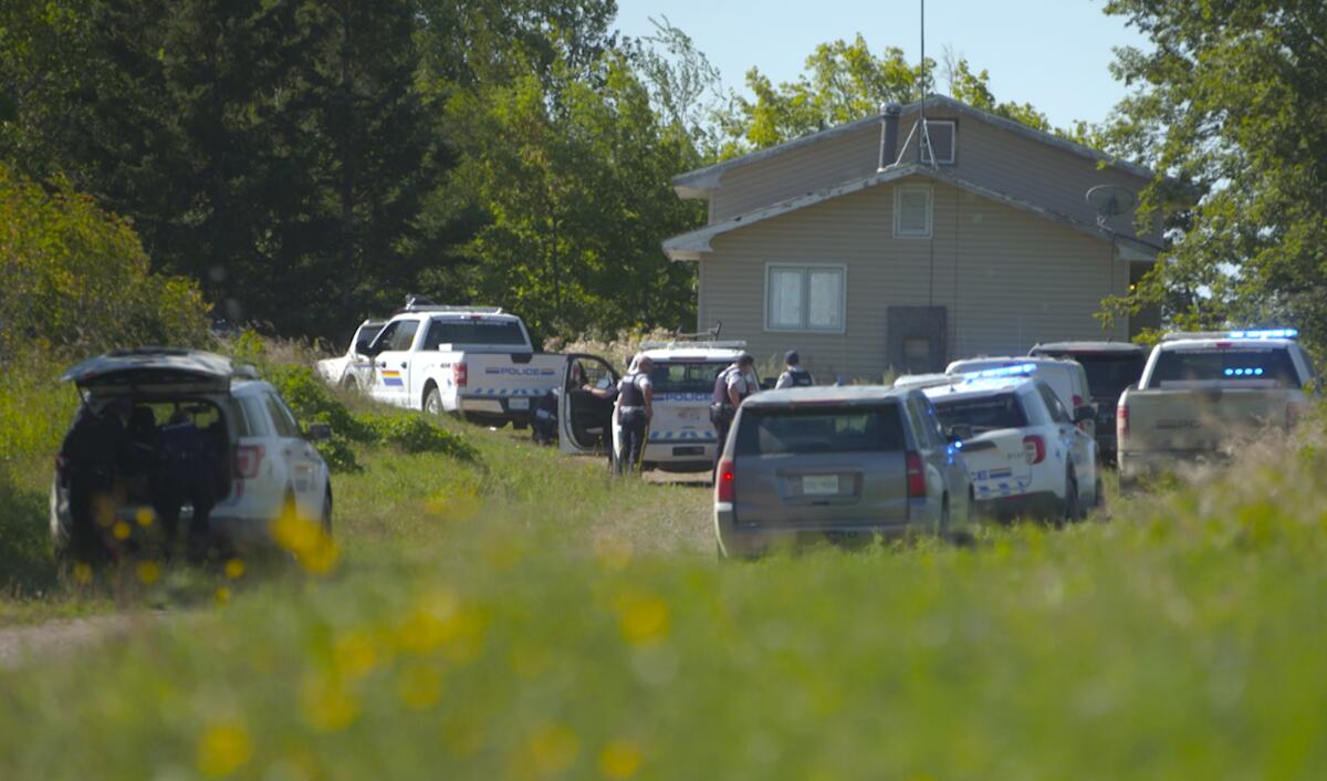 In this image taken from video, Canadian law enforcement personnel surrounded a residence on the James Smith Cree First Nation reservation in Saskatchewan, Canada, Tuesday, Sept. 6, 2022, as they search for a suspect in a series of stabbings. (AP Photo/Robert Bumsted)