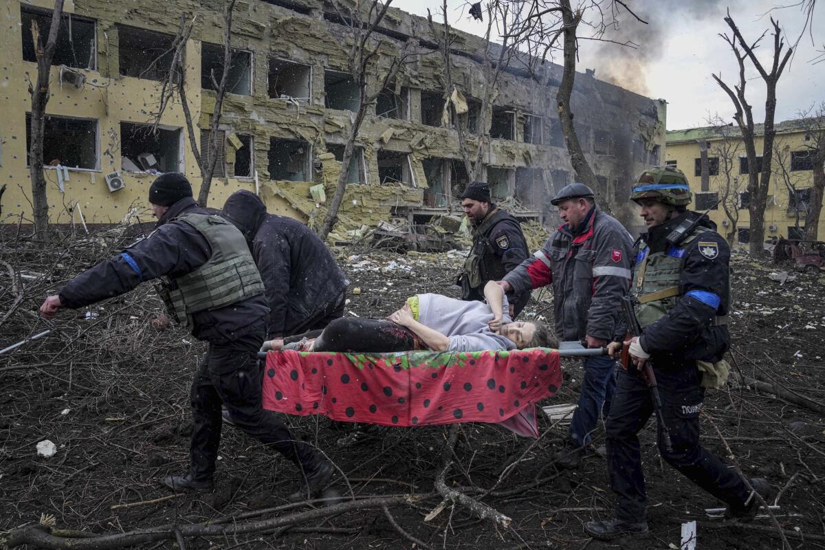 An injured pregnant woman is carried on a stretcher in Ukraine.